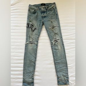 Blue Amiri Jeans featuring black bandana brand name.